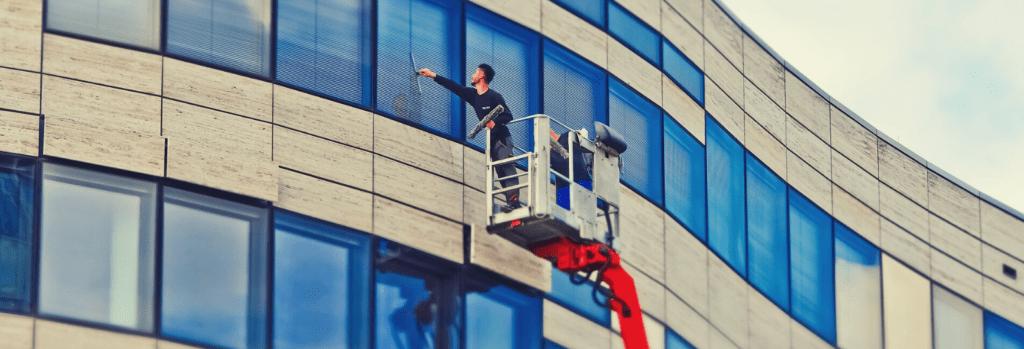 Man cleaning office windows